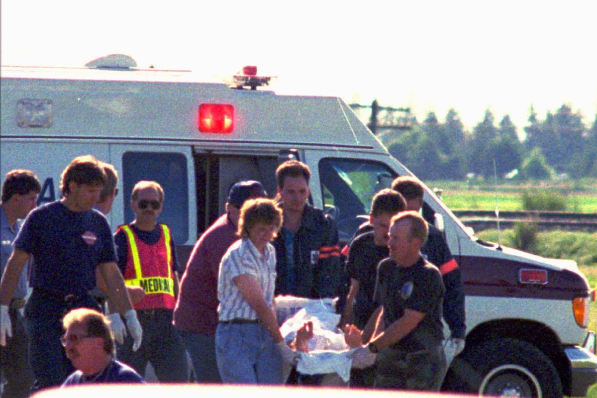 Medical crews move a shooting victim from an ambulance to a helicopter Monday, June 20, 1994, after a gunman opened fire at Fairchild Air Force Base outside of Spokane. Dean Mellberg killed four people before being fatally shot. Twenty three others were wounded by the gunman, who was an airman at the base. (FILE / Associated Press)