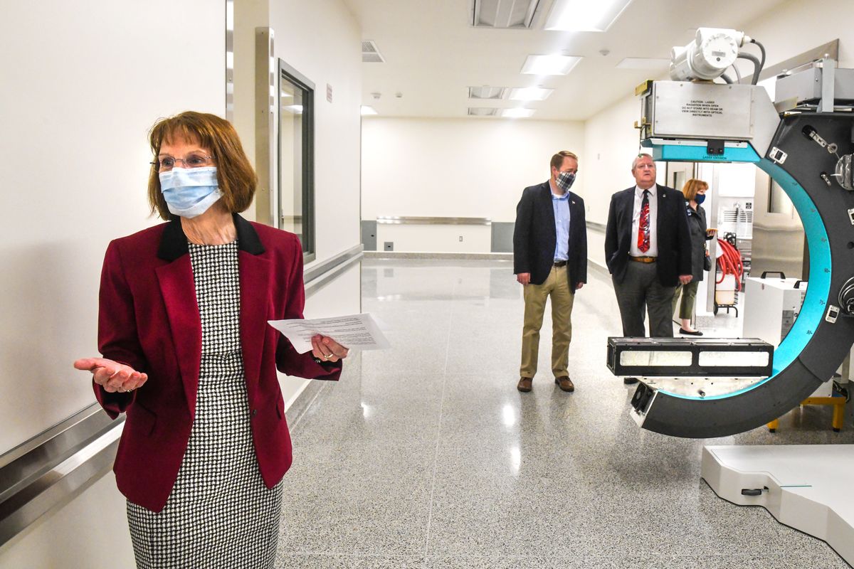 Spokane County Medical Examiner Dr. Sally Aiken, left, conducts a tour of the new facility, Tuesday, June 16, 2020. Spokane County Commissioners Josh Kerns and Al French, center and right, take a close look at the new Lodox full-body scanner located near the autopsy rooms.  (DAN PELLE/THE SPOKESMAN-REVIEW)