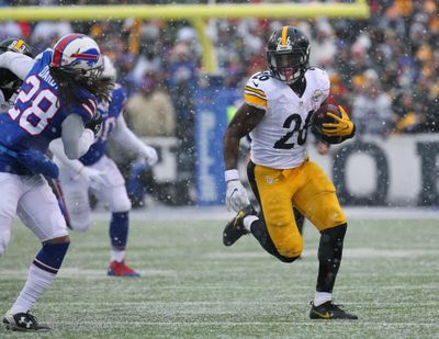 In this Dec. 11, 2016, file photo, Pittsburgh Steelers running back Le’Veon Bell (26) carries against the Buffalo Bills during the second half of an NFL football game in Orchard Park, N.Y. Bell has suggested on Twitter that he will return to the team on Sept. 1, the day after Pittsburghs final preseason game. Bell hasn’t signed his franchise tender and has been holding out through training camp. Responding to a fan Tuesday night, Aug. 22, asking when he plans to end his holdout, Bell wrote “9-1-17” and added a wink. (Bill Wippert / Associated Press)