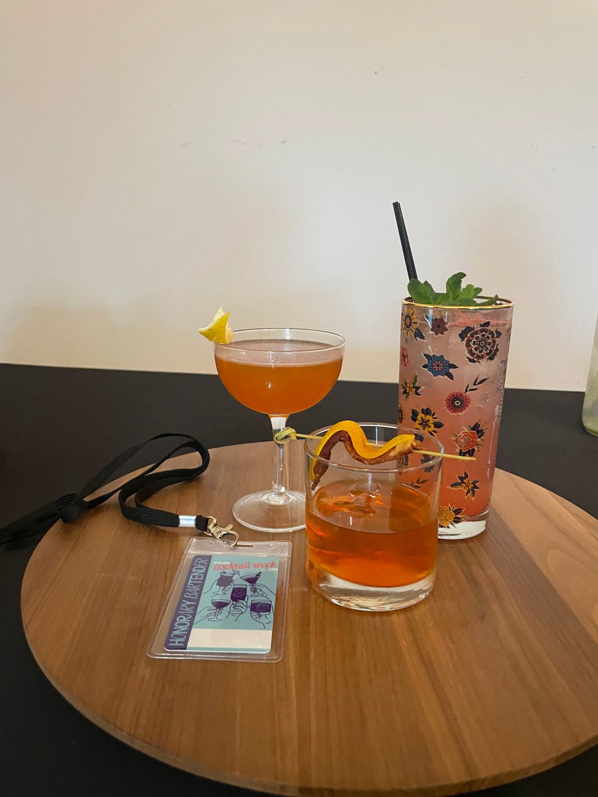 An honorary bartender placard rests near drinks made by bartenders from Emma Rue’s, left, Hogwash Whiskey Den and Uno Mas Taco Shop.  (Lindsey Treffry/The Spokesman-Review)
