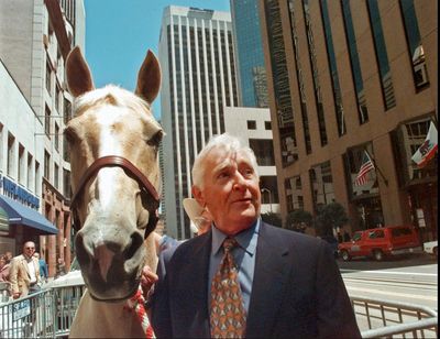 In this July 31, 1997 file photo, actor Alan Young of the “Mister Ed” television series, poses with Mister Ed-For-A-Day, “Champagne,” a 13-year-old Palomino mare, in San Francisco. (Susan Ragan / Associated Press)