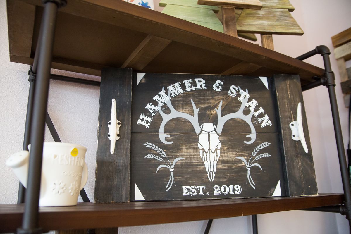 A sign at Hammer and Stain, a do-it-yourself crafts shop that opened in September 2019 by owner Julie Markquart, is seen at the shop at 121 S. Sullivan Road in Spokane Valley. For more information, call (509) 474-9702 or email hammerandstainspokanevalley@gmail.com. The shop also offers retail items and group workshops. It is open every day.  ( Libby Kamrowski /THE SPOKESMAN-REVIEW)