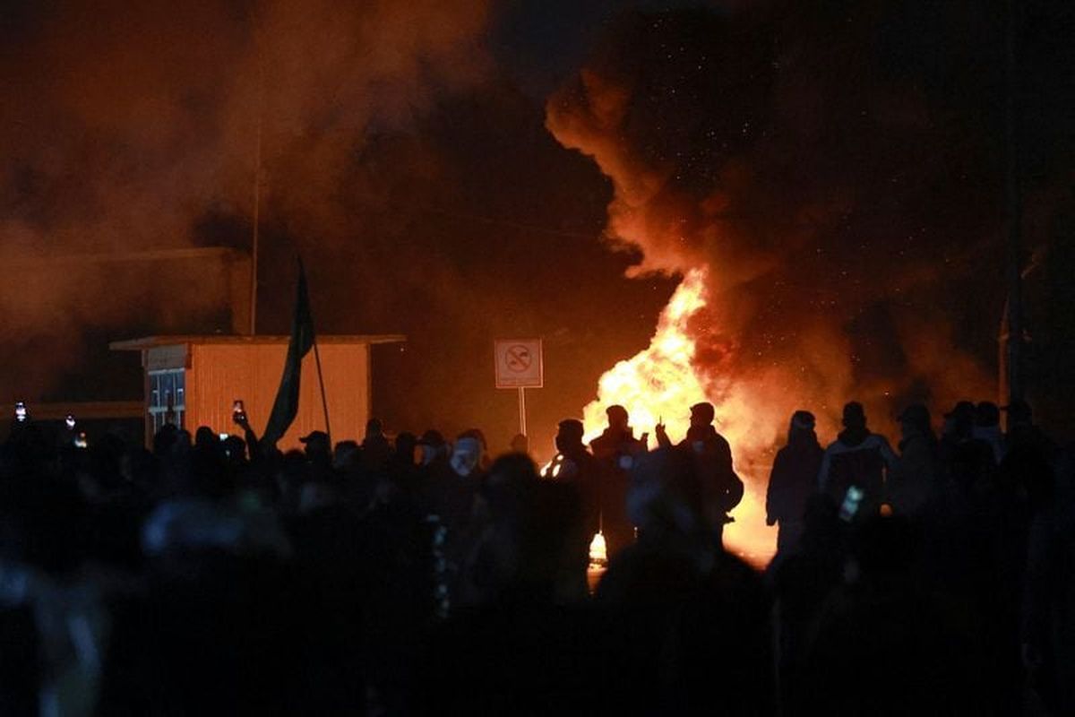 Smoke billows from a fire as supporters of Iraqi Shi’ite armed groups attempt to move toward the U.S. embassy located in Baghdad’s Green Zone, while riot police deploy to block their advance, following the Israel and U.S. strikes on Iran and the killing of Iran’s Supreme Leader on Sunday in Baghdad, Iraq. (Reuters )