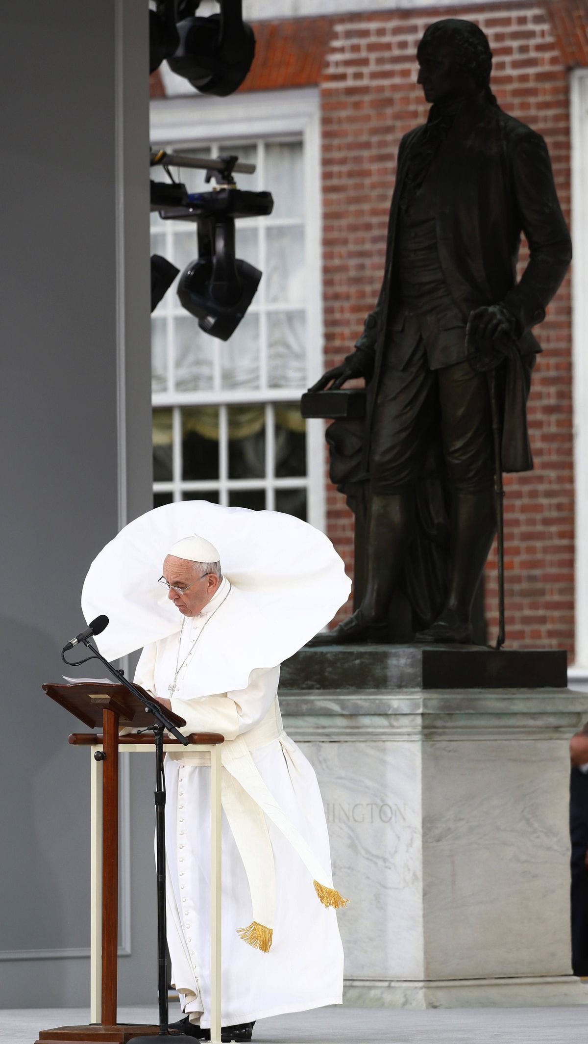 The wind lifts Pope Francis’ mantle as he delivers his speech Saturday in front of Independence Hall in Philadelphia. (Associated Press)