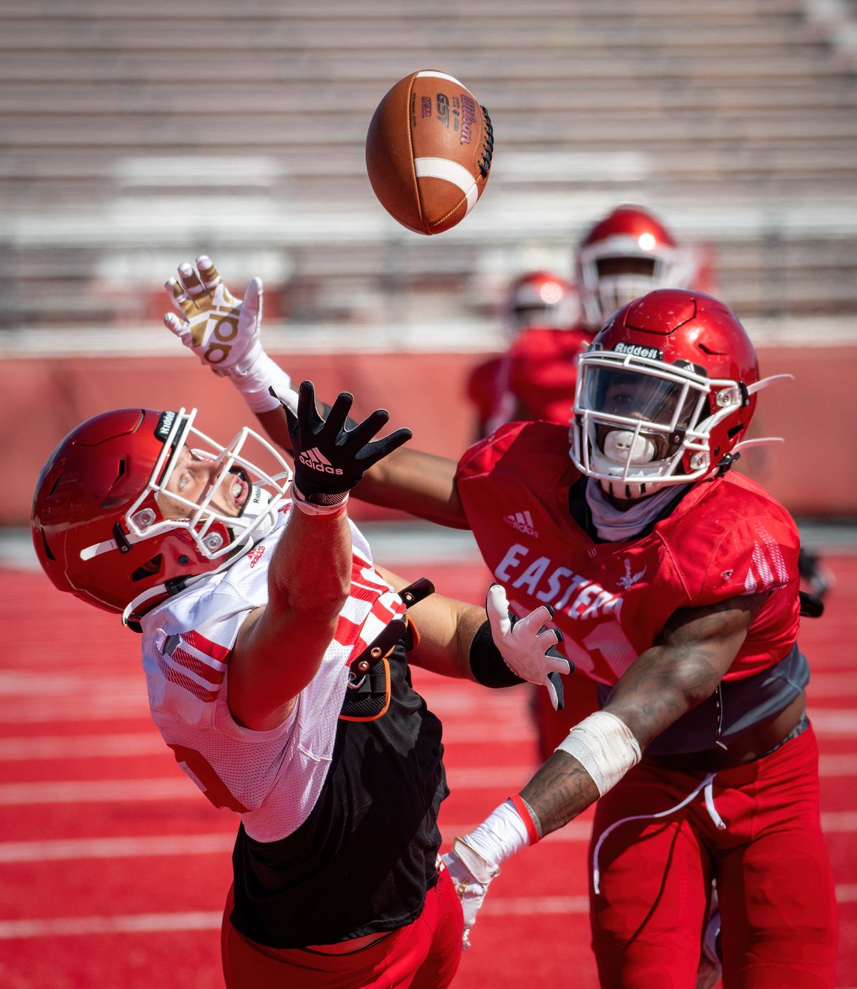 EWU wide receiver Efton Chism III on left, eyes a just-out-of-reach pass as defensive back Demetrius Crosby Jr. defends during a scrimmage, Wed. August 18, 2021.  (COLIN MULVANY/THE SPOKESMAN-REVIEW)