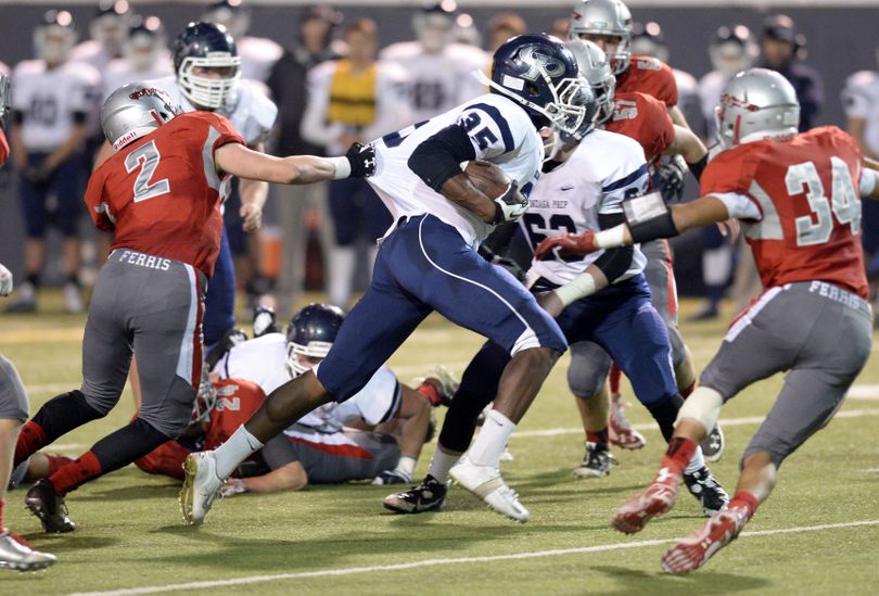 Ferris' Tim Kirby (2) and Lamarr Speights (34) try to slow down Gonzaga Prep's Jack Bamis (35) on the run up the middle Thursday, Oct. 30, 2014 at Joe Albi Stadium. (Jesse Tinsley / The Spokesman-Review)