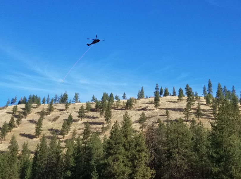 A helicopter hauls materials for an Avista transmission line project over the South Hill bluff on Oct. 23, 2017. (Rich Landers)