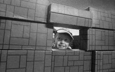 Kaden Foreman, 3, peeks through the side of a block structure that he and his sister Erika were building at Block Fest, part of the Day of the Child and Books celebration Thursday at the Harding Family Center in Coeur d'Alene. Several child-centered nonprofit groups put on the event.
(Photos by JESSE TINSLEY / The Spokesman-Review)