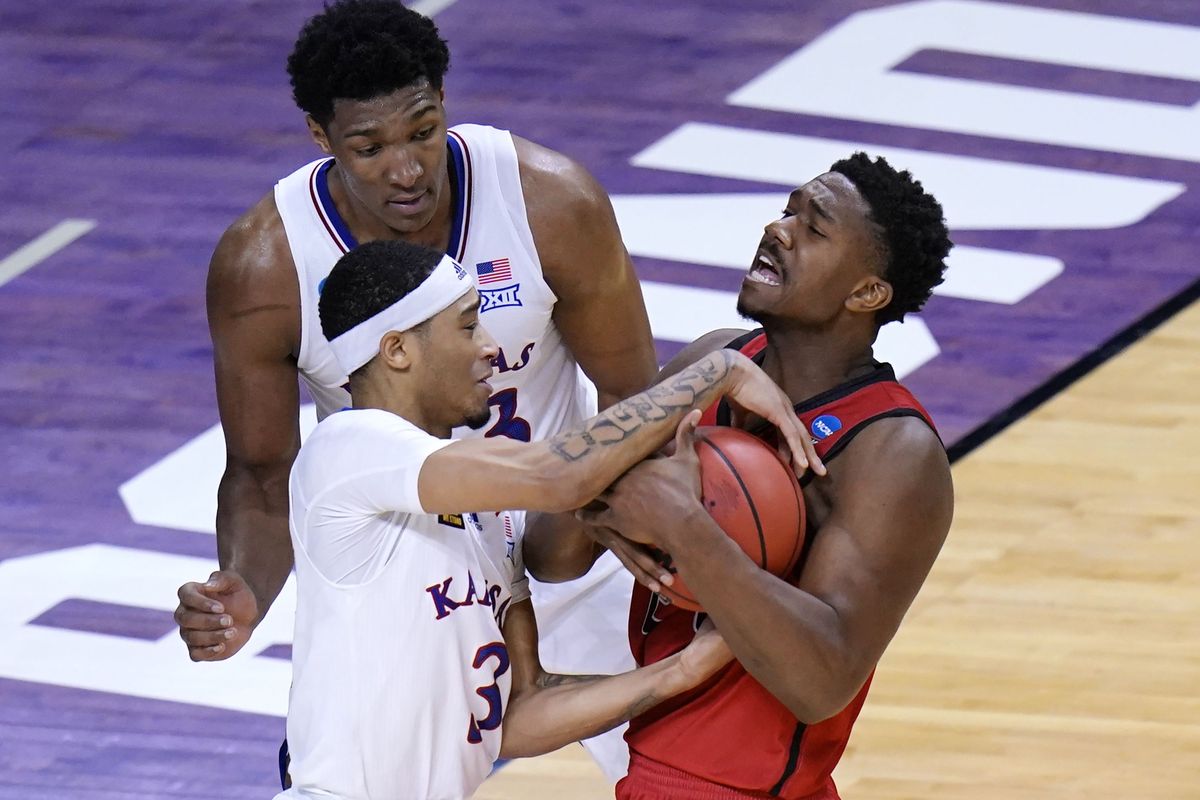 Kansas guard Dajuan Harris (3) battles Eastern Washington guard Kim Aiken Jr. (24) battle for the ball during the second half of a first-round game in the NCAA college basketball tournament at Farmers Coliseum in Indianapolis, Saturday, March 20, 2021.   (Associated Press)