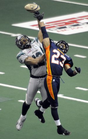 Spokane Shock Rodrerick Mosley (23) and Bossier-Shreveport's Randy Hymes battle for a 2nd quarter pass.  Hymes tipped the ball to himself for the completion, April 17, 2010 in the Spokane Arena. (Dan Pelle / The Spokesman-Review)