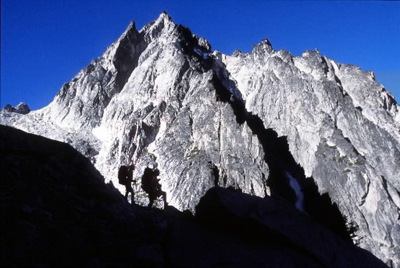 Hikers near Aasgard Pass in the Alpine Lakes Wilderness; Dragontail Peak in background. (Rich Landers)