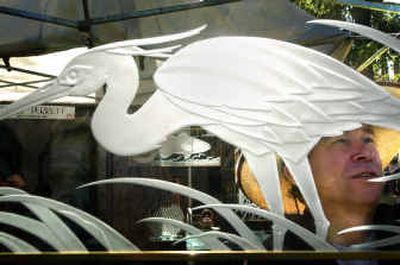
Jerry Perrett readies his ArtFest booth at Coeur d' Alene Park on Saturday. He and his wife, Rayetta, make glass etchings using a sandblasting method. 
 (Jed Conklin / The Spokesman-Review)