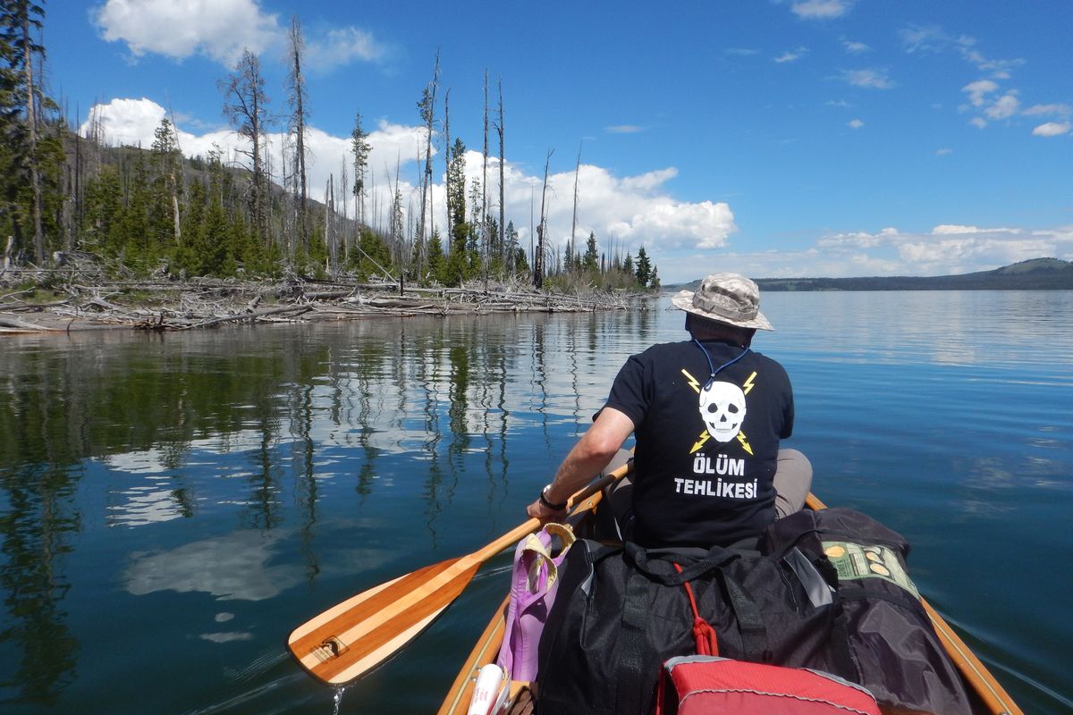 Scott Close, formerly of Bozeman, paddles north on the southeast arm of Yellowstone Lake. To his left is the promontory that separates the lake’s south arm from its southeast arm.  (Photo courtesy of William Brock)