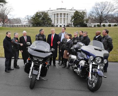 President Donald Trump and Vice President Mike Pence meet with Harley Davidson executives and union representatives on the South Lawn of the White House on Feb. 2. A lobbyist for Harley warned that imposing additional tariffs on foreign imports could end up hurting motorcycle sales. (Pablo Martinez Monsivais / Associated Press)