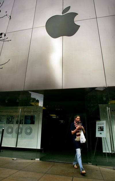 A shopper leaves an Apple store at The Grove in Los Angeles. (Associated Press)