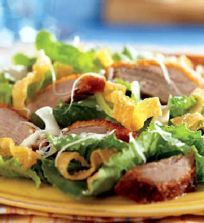 
Asian Grilled Duck Salad is tossed with romaine and topped with slices of grilled, marinated duck breast, garnished with crisp won ton strips and sesame seed. 
 (Associated Press / The Spokesman-Review)