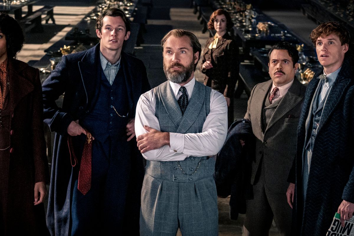 This image released by Warner Bros. Pictures shows, from left, Jessica Williams, Callum Turner, Jude Law, Fionna Glascott, Dan Fogler and Eddie Redmayne in a scene from "Fantastic Beasts: The Secrets of Dumbledore."  (Warner Bros. Pictures)