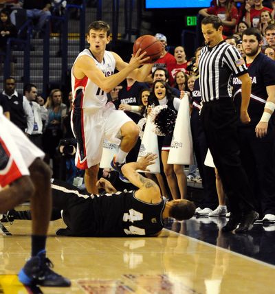 Gonzaga’s David Stockton leaps over Bryant’s Claybrin McMath to make a second-half pass. (Associated Press)