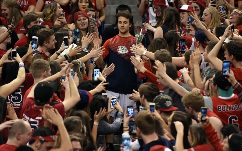 Gonzaga guard Kevin Pangos makes his way through the Kennel Club student section on Senior Night. (Colin Mulvany)