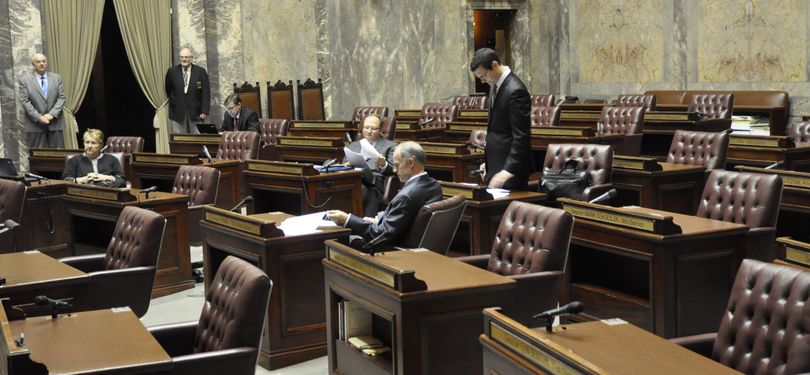 OLYMPIA -- Sen. Joe Fain, R-Auburn, Majority Coalition floor leader, moves through the pro forma opening of the Legislature's Third Special Session with Sen. Rodney Tom, D-Medina, foreground, and Sens. Karen Fraser, D-Olympia, Brian Hatfield D-Raymond and David Frockt, D-Seattle, (l-to-r in background) (Jim Camden)