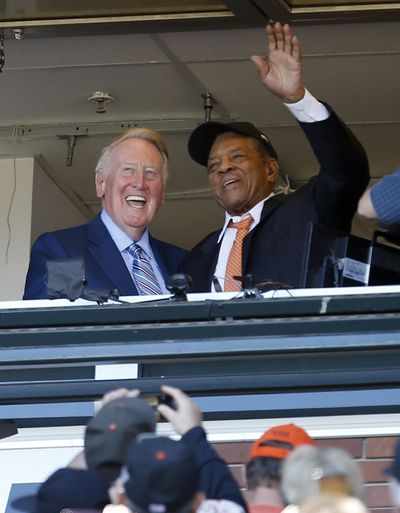 Hall of Fame baseball player Willie Mays waves as fans honor Los Angeles Dodgers announcer Vin Scully during the Sunday’s game between Los Angeles and the Giants in San Francisco. The game was Scully’s last behind the microphone. (Tony Avelar / Associated Press)