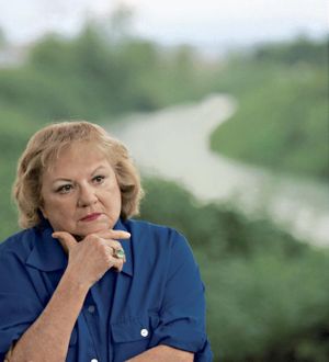 This July 2004 file photo shows, true-crime author Ann Rule, who wrote a book about serial killer Gary Ridgway, who left some of his victims’ bodies along the Green River outside Seattle, Wash., shown in the background. Rule, who wrote more than 30 books, including a profile of her former co-worker, serial killer Ted Bundy, has died at age 83. Scott Thompson, a spokesman for CHI Franciscan Health, said Rule died at Highline Medical Center at 10:30 p.m. Sunday, July 26, 2015.  (Betty Udeson photo)