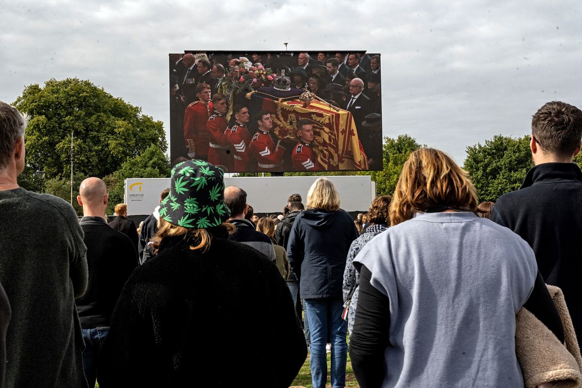 Mourners at Hyde Park in London watch a video feed of the funeral for Queen Elizabeth II on Monday.  (LYNSEY ADDARIO/New York Times)