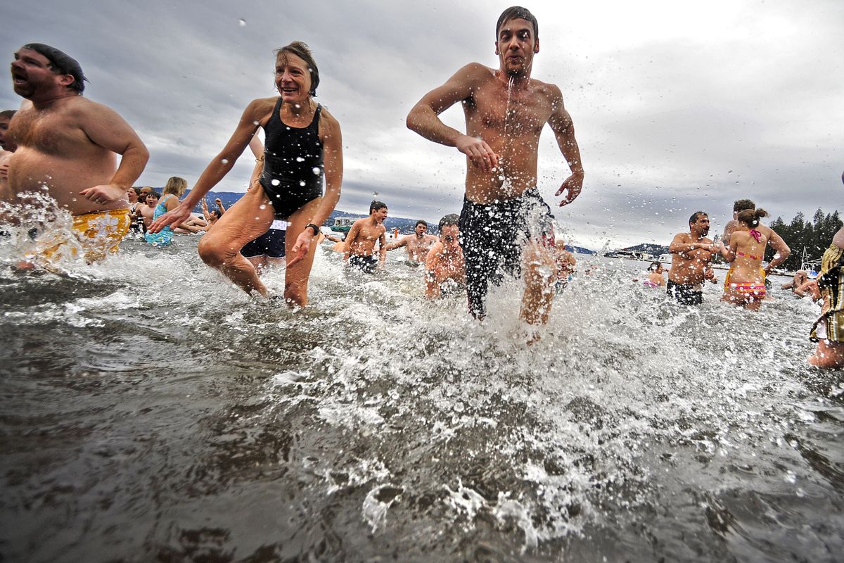 Polar Bear Plunge participants dash into Lake Coeur d’Alene in celebration of New Year’s Day.