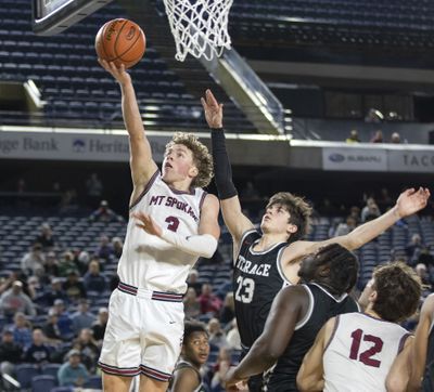 Mt. Spokane’s Ryan Lafferty, left, goes in for 2 of his game-high 27 points in front of the defense of Mountlake Terrace’s Jaxon Dubiel during quarterfinal action Thursday, Feb. 29, 2024, at the 3A State Boys Basketball Tournament in Tacoma, Wash. Mt. Spokane won the game 82-58 to advance to the Semi-Finals.  (Patrick Hagerty/For The Spokesman-Review)