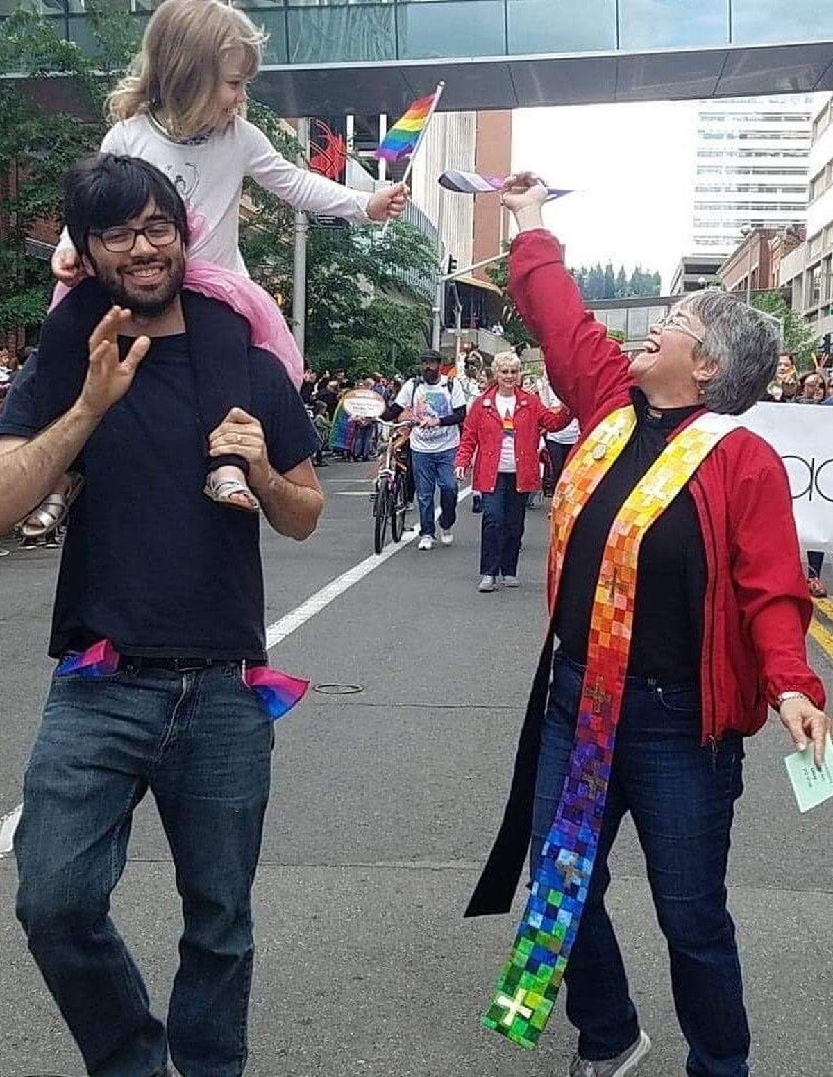 The Rev. Andrea CastroLang, high-fiving a child at Spokane’s Pride Parade, received the honorary title pastor emerita in recognition of her 20 years of ministry in the Westminster United Church of Christ.  (Courtesy)