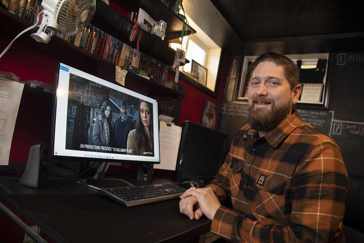 Local filmmaker Jesse James Hennessy sits by his basement editing desk Wednesday in the Garland District. On the screen of his computer is a promotional still photo from his latest project, a short film titled “13 Callaway Place.”  (Jesse Tinsley/THE SPOKESMAN-REVIEW)