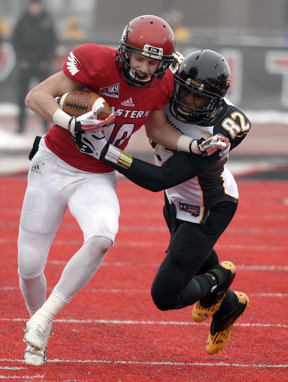 Eagles receiver Cooper Kupp, left, is tackled out of bounds by Tigers defender Syd Holt. (Colin Mulvany)