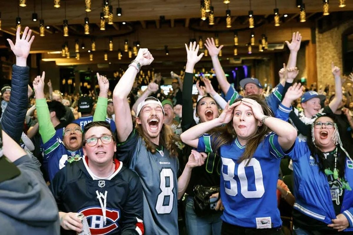 Fans react while watching the Seahawks in Super Bowl 60 at Victory Hall in Seattle on Sunday.  (Karen Ducey/Seattle Times)