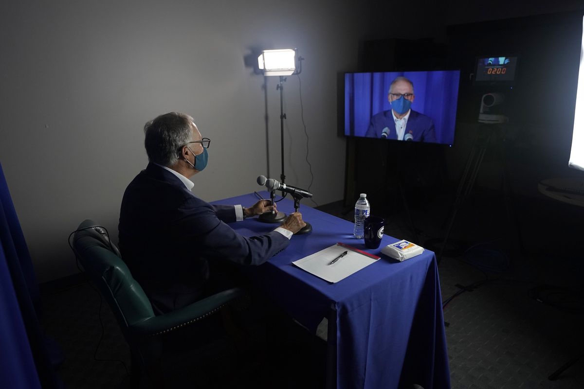 Washington Gov. Jay Inslee, a Democrat, takes part in a sound check in the room he used for his debate with Republican Loren Culp last Wednesday in Olympia. Due to concerns over COVID-19, each candidate participated in the debate from individual rooms separate from moderators.  (Ted S. Warren)