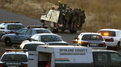 
Spokane County SWAT team members prepare to enter the Valley Breeze mobile home park  Friday,  where an armed man had fired shots and was holed up in one of the units. 
 (Christopher Anderson / The Spokesman-Review)