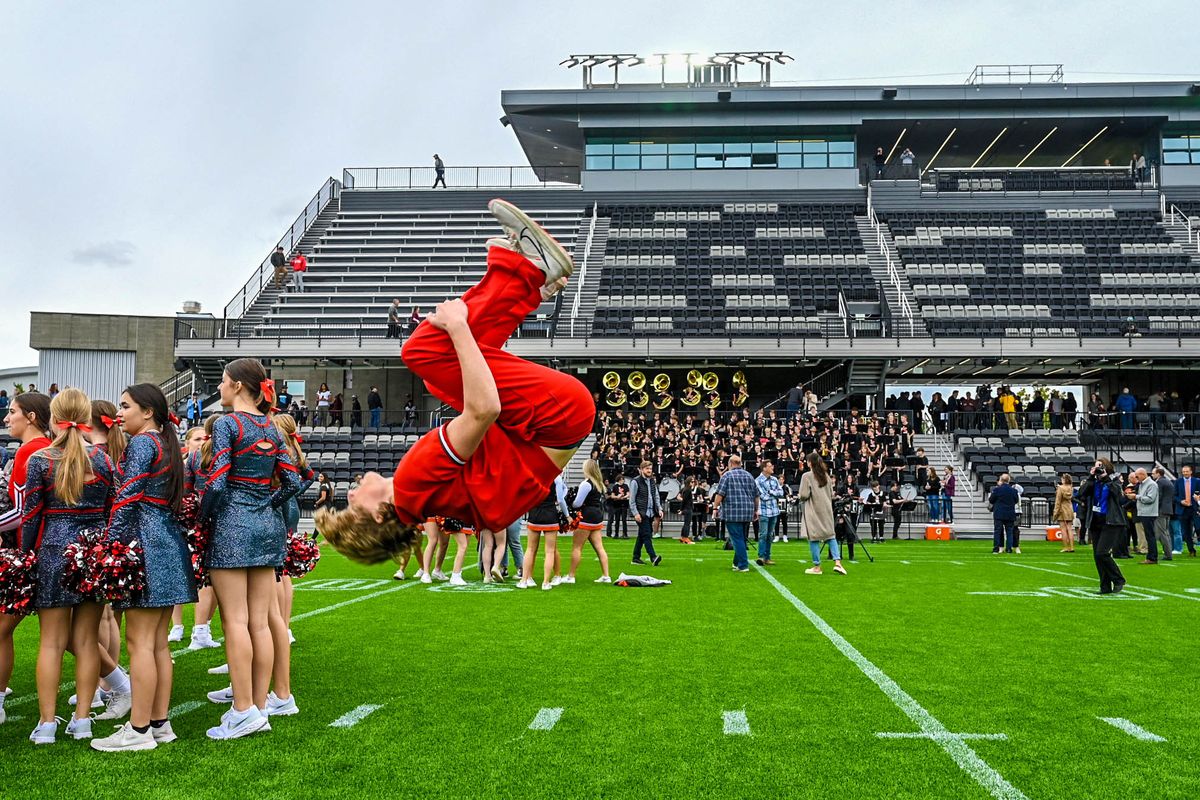 Ferris High School cheer team member Bodie Grangroth backflips on the turf after a ribbon cutting ceremony for ONE Spokane Stadium on Tuesday in Spokane.  (DAN PELLE/THE SPOKESMAN-REVIEW)