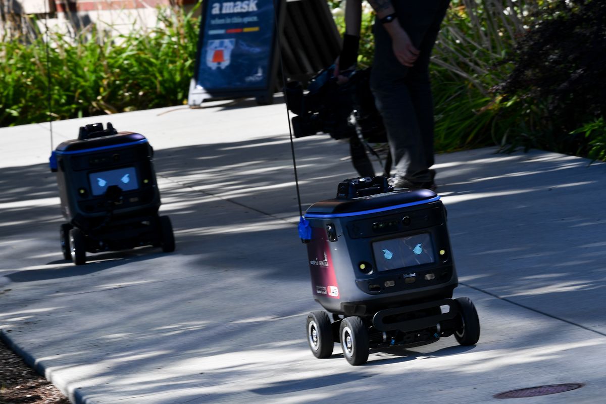 Kiwibot food delivery robots are unveiled during a press conference on Tuesday, Sep 21, 2021, at Gonzaga University in Spokane, Wash. The Sodexo Bite for Universities app, allows GU students, faculty and visitors to order from the Sodexo-serviced campus location using their dining dollars or a debit or credit card, and the Kiwibots deliver food via a locked compartment that only the recipient can open through the app. Each robot is thoroughly sanitized between deliveries.  (Tyler Tjomsland/The Spokesman-Review)