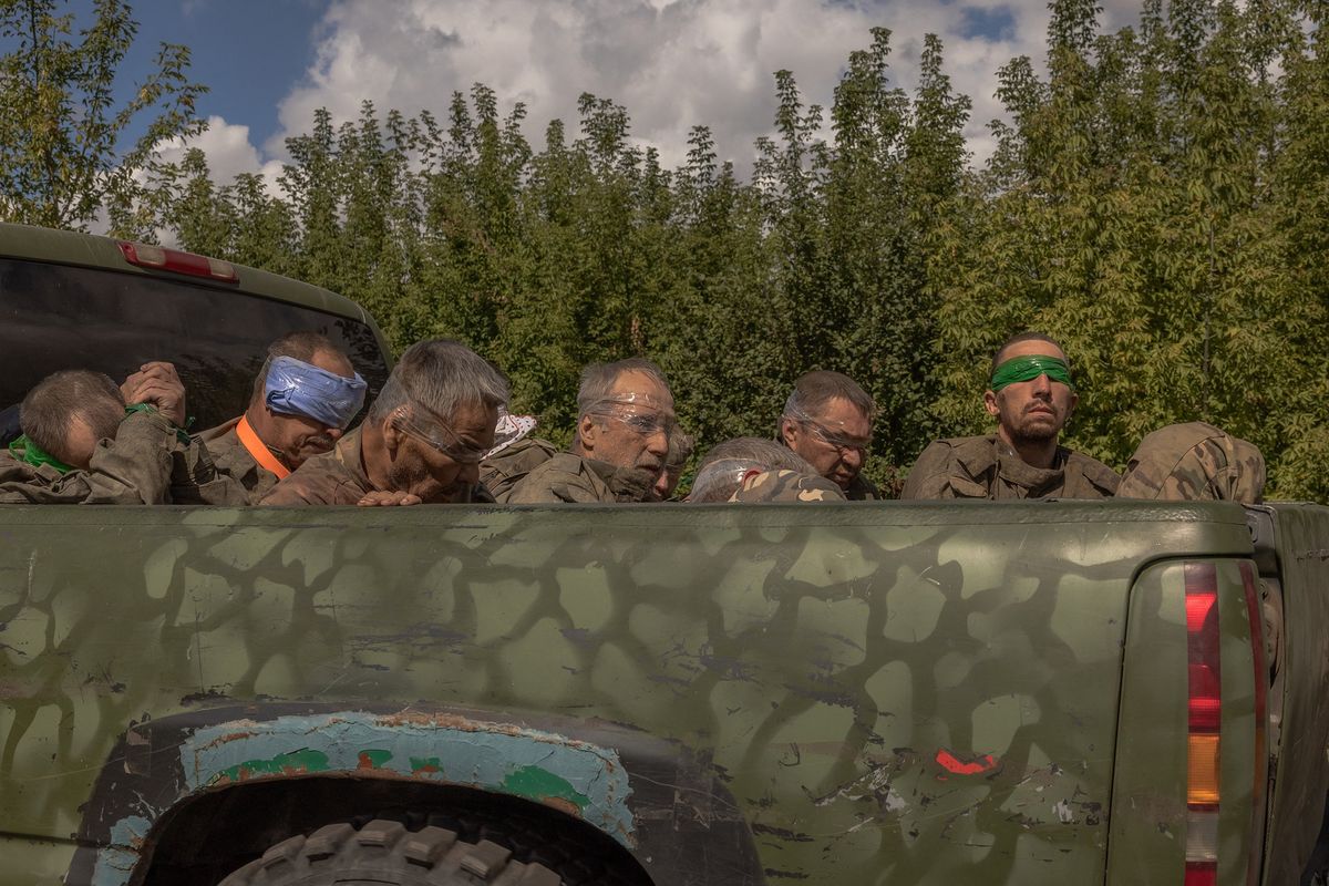 A Ukrainian military vehicle drives from the direction of the border with Russia carrying blindfolded men in Russian military uniforms, in the Sumy region, on Aug. 13, 2024, amid the Russian invasion of Ukraine. (Roman Pilipey/AFP/Getty Images/TNS)  (Roman Pilipey/AFP)