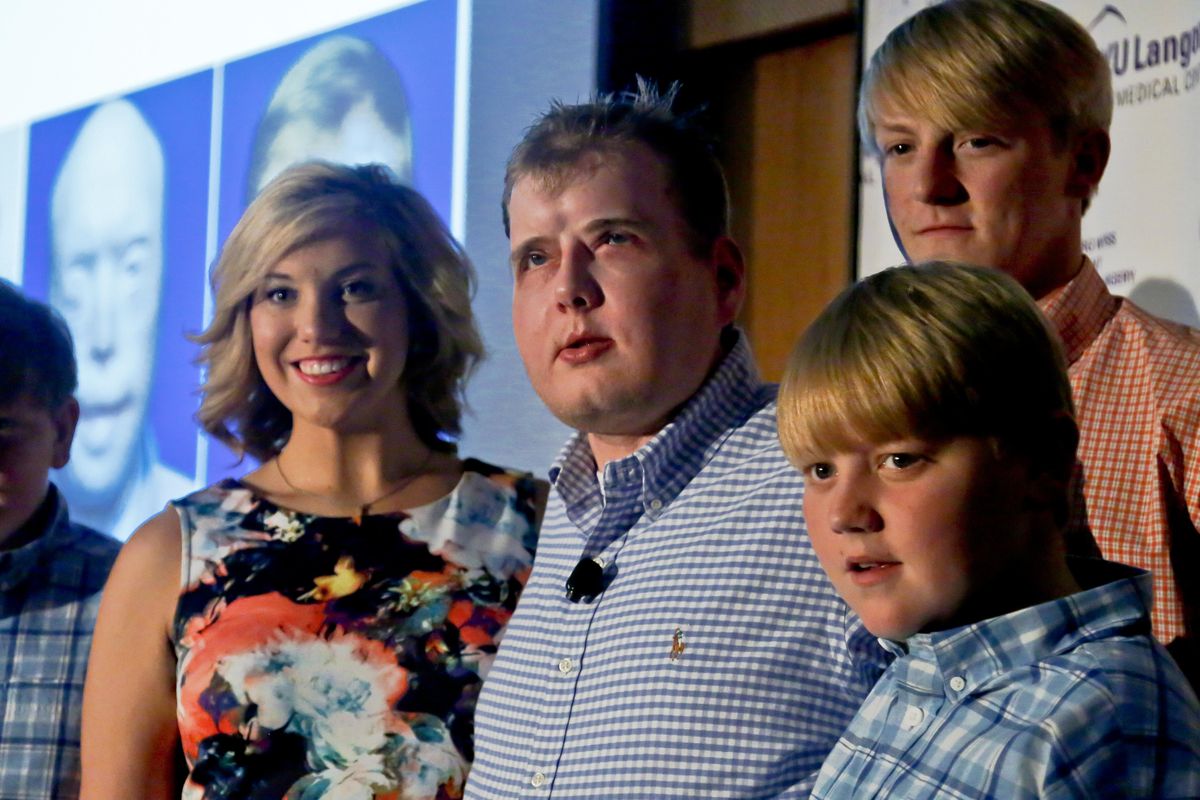 Former Mississippi firefighter Patrick Hardison, 42, center, is surrounded with his children Braden, 13, far left, Allison, 21, second from left, Cullen, 12, far right, and Dalton, 18, second from right, at a news conference marking one year after his face transplant surgery, Wednesday Aug. 24, 2016, in New York. (Bebeto Matthews / AP)