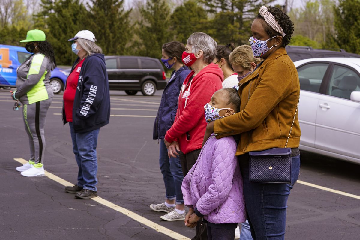 People gather for a prayer during a vigil at the Missionary Baptist Church in Indianapolis, Saturday, April 17, 2021 for the victims of the shooting at a FedEx facility. A gunman killed eight people and wounded several others before taking his own life in a late-night attack at a FedEx facility near the Indianapolis airport, police said.  (Michael Conroy)