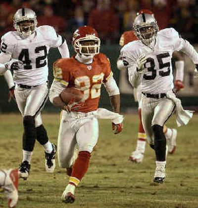 
Kansas City's Dante Hall (82) is chased by Oakland's Keyon Nash, left, and David Terrell during his 49-yard kickoff return that set up the winning field goal.
 (Associated Press / The Spokesman-Review)