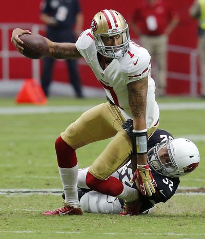 Arizona’s Tyrann Mathieu tackles 49ers quarterback Colin Kaepernick during the Cardinals’ victory. (Associated Press)