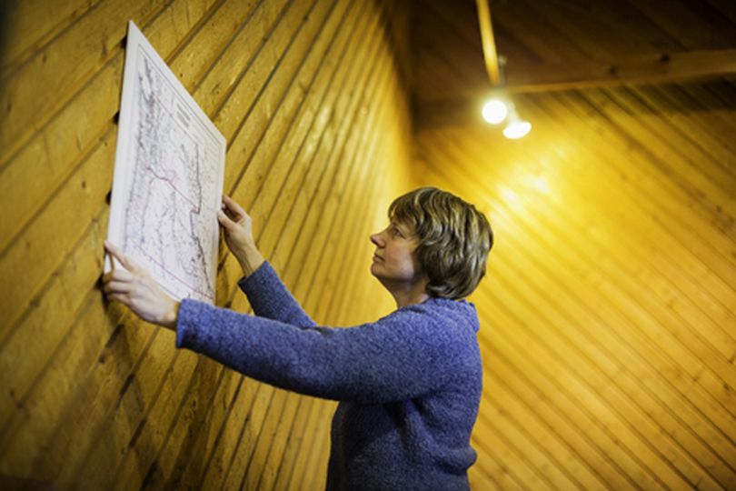 Dorothy Dahlgren, director of the Museum of North Idaho in Coeur d'Alene, places a map against a wall Tuesday while working on an upcoming exhibit. The museum's first membership drive ends in April. (Shawn Gust/press)