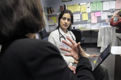 Faculty attending physician Judy Swanson, left, reviews a patient history with resident physician Sandeep Atwal  at the Internal Medicine Residency Spokane clinic last Tuesday.  (Christopher Anderson / The Spokesman-Review)