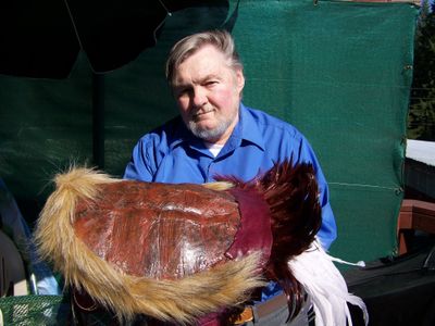 Bob Fletcher holds a turtle shell helmet from the Ghengis Khan era. (Herb Huseland / The Spokesman-Review)