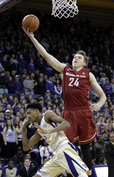 Washington State’s Josh Hawkinson (24) shoots as Washington’s Dejounte Murray defends during the first half of an NCAA college basketball game Wednesday, March 2, 2016, in Seattle. (Elaine Thompson / Associated Press)