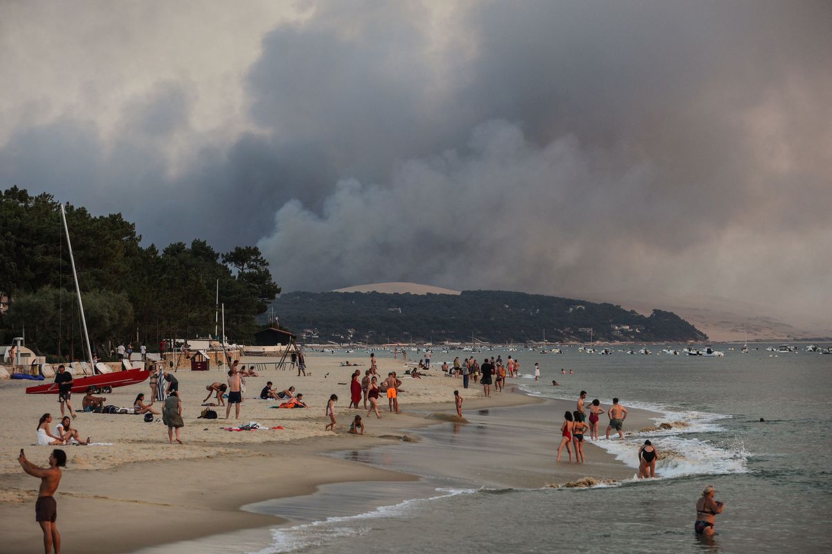 This photograph taken on July 18, 2022, shows people swim on the Moulleau