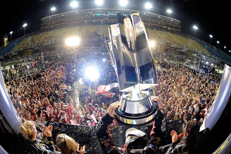 Tony Stewart shows off the Sprint Cup trophy in Victory Lane at Homestead-Miami Speedway after securing his third crown in NASCAR's premier series on Sunday, Nov. 20. Photo Credit: By John Harrelson, Getty Images for NASCAR (John Harrelson / Getty Images North America)