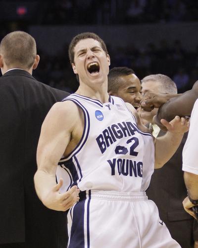 BYU guard Jimmer Fredette celebrates a 3-pointer during the Cougars’ overtime win.  (Associated Press)