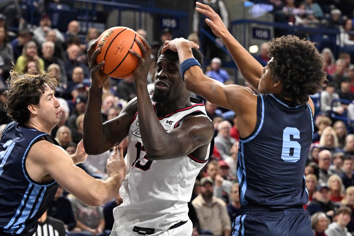 Gonzaga’s Graham Ike looks to pass against San Diego guard Kody Clouet (left) and guard Tony Duckett, whose hand is on Ike’s head, during GU’s win Wednesday.  (COLIN MULVANY/THE SPOKESMAN-REVIEW)